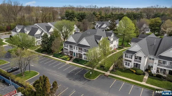 an aerial view of multiple houses with yard