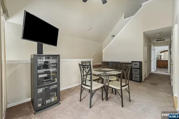 a view of a livingroom with furniture and a flat screen tv