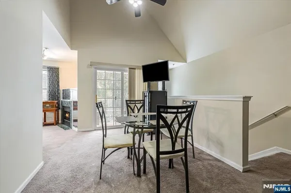 a view of a dining room with furniture and a flat screen tv