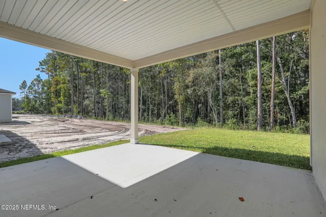 a view of a house with backyard and a backyard