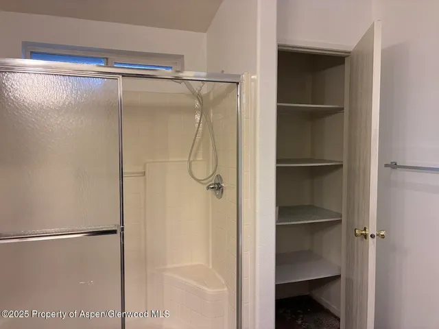 a bathroom with a glass shower door