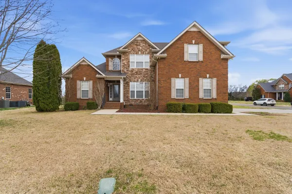 a front view of a house with a yard