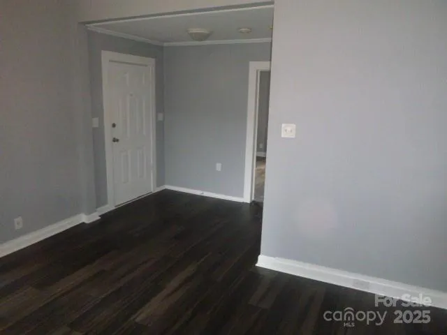 an empty room with wooden floor