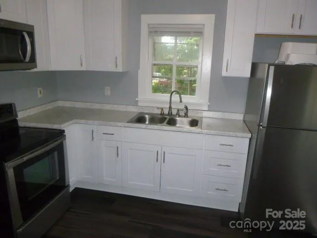 a kitchen with white cabinets and a sink