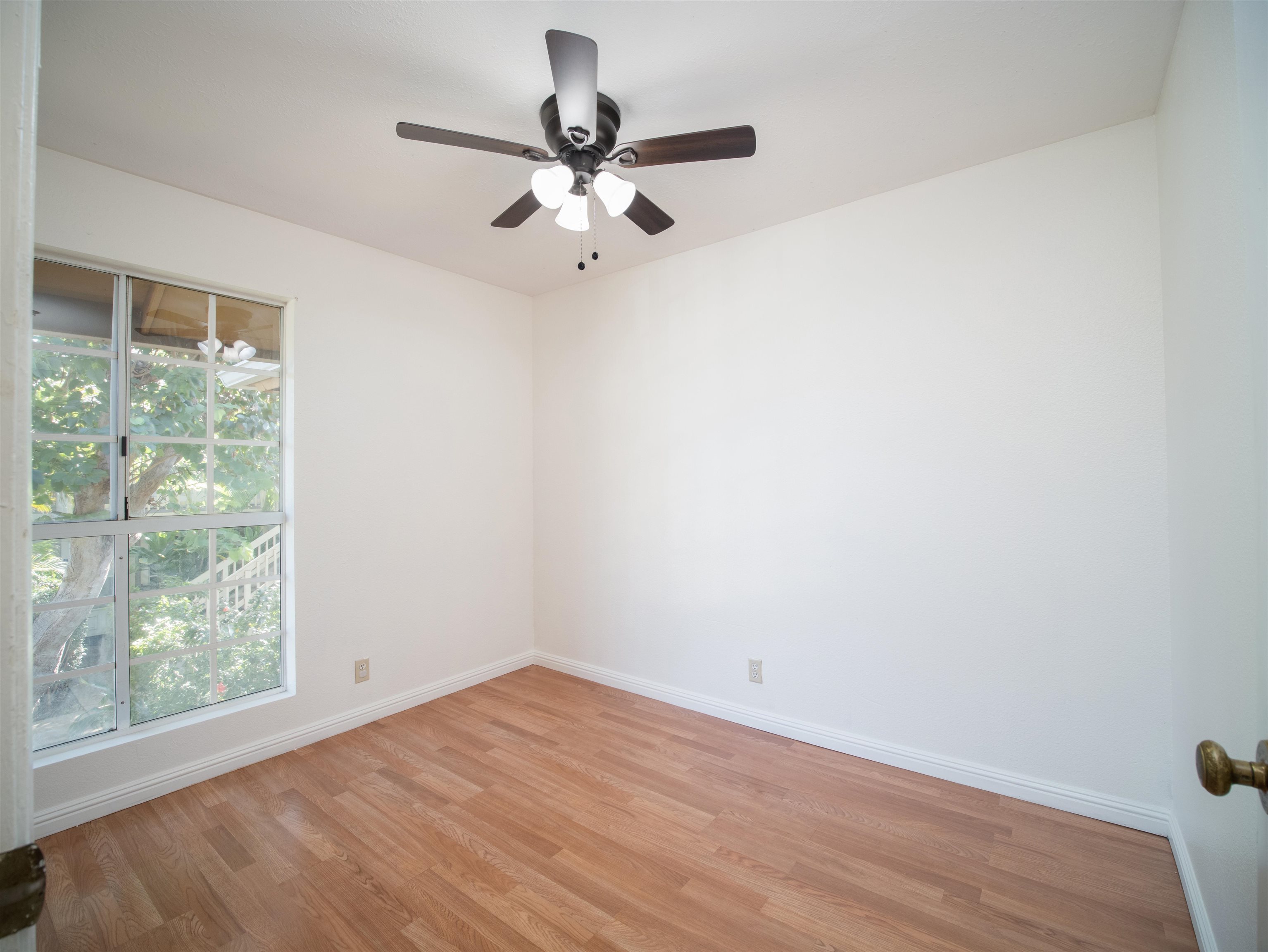 140 Uwapo Road, Unit 43204 Kihei, HI 96753 - Photo 13 of 21 a view of a room with wooden floor and a ceiling fan