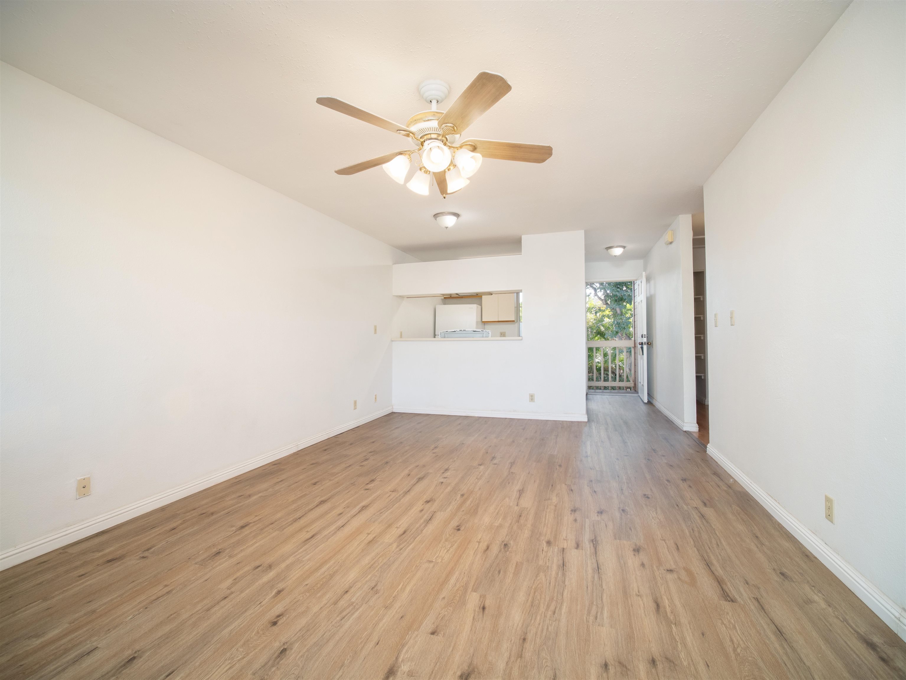 140 Uwapo Road, Unit 43204 Kihei, HI 96753 - Photo 2 of 21 wooden floor in an empty room with a window