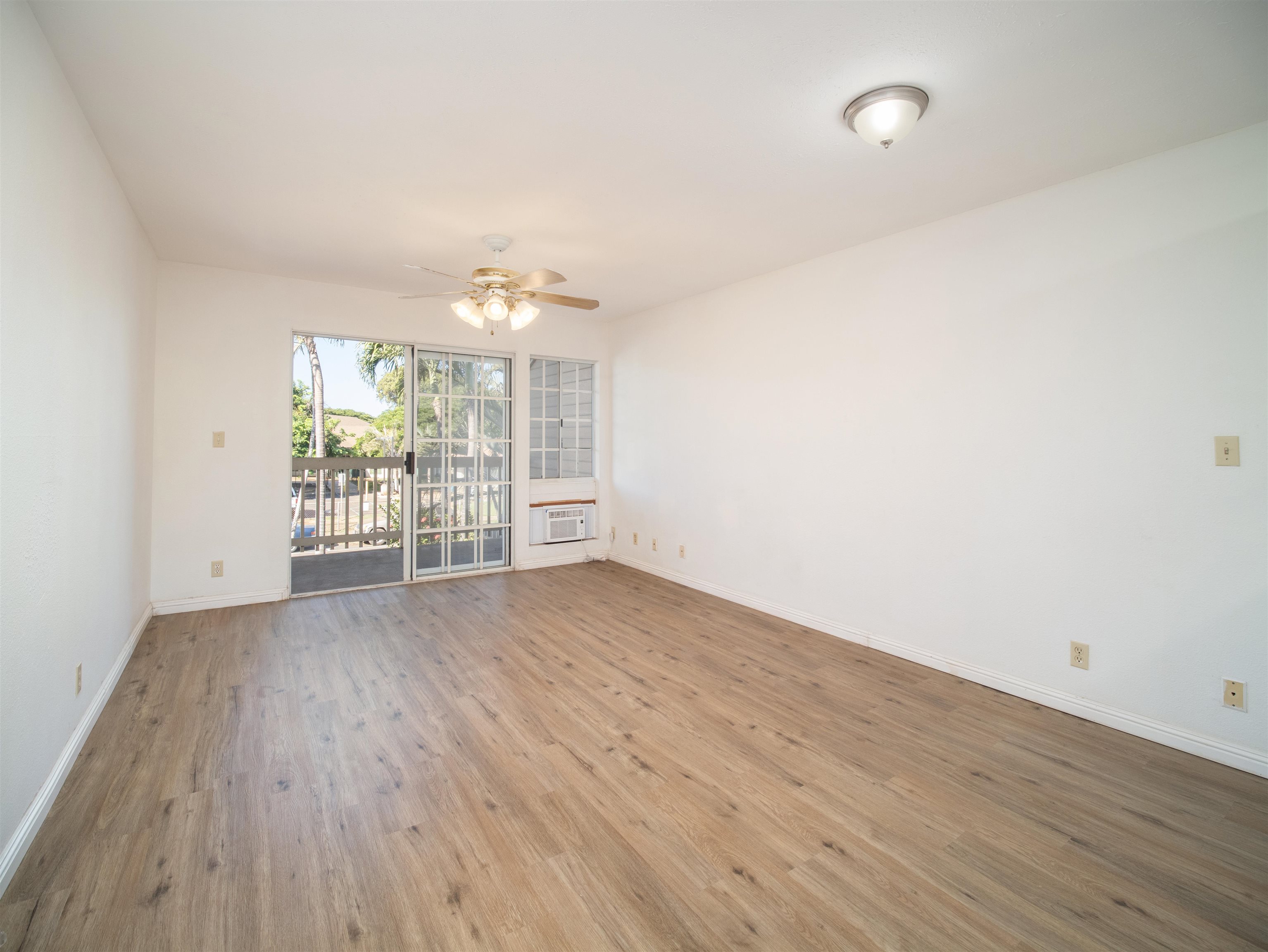 140 Uwapo Road, Unit 43204 Kihei, HI 96753 - Photo 3 of 21 wooden floor in an empty room with a window