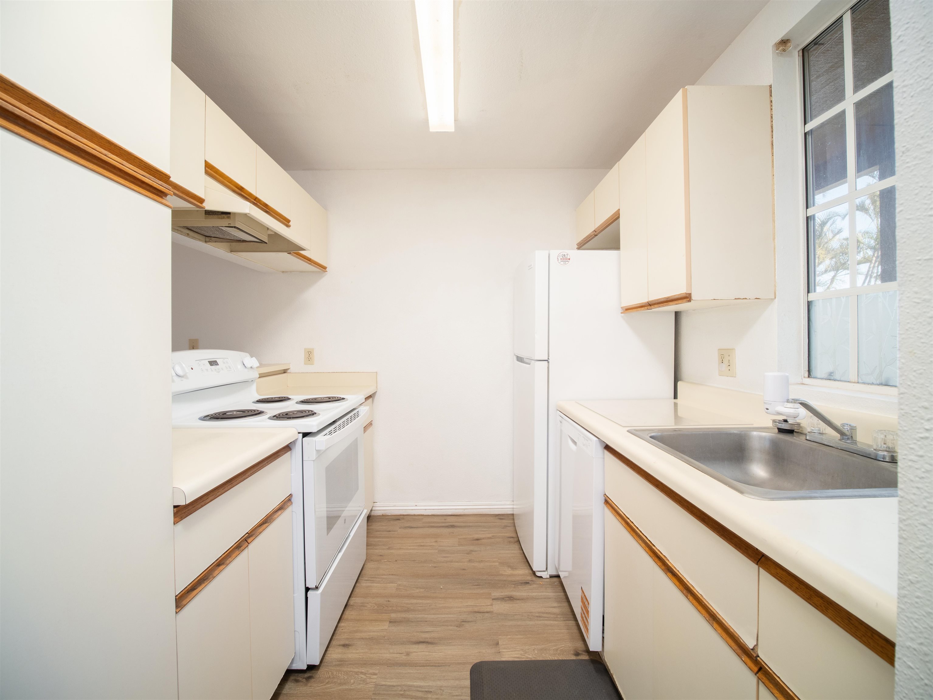 140 Uwapo Road, Unit 43204 Kihei, HI 96753 - Photo 8 of 21 a kitchen with a sink stove top oven and cabinets