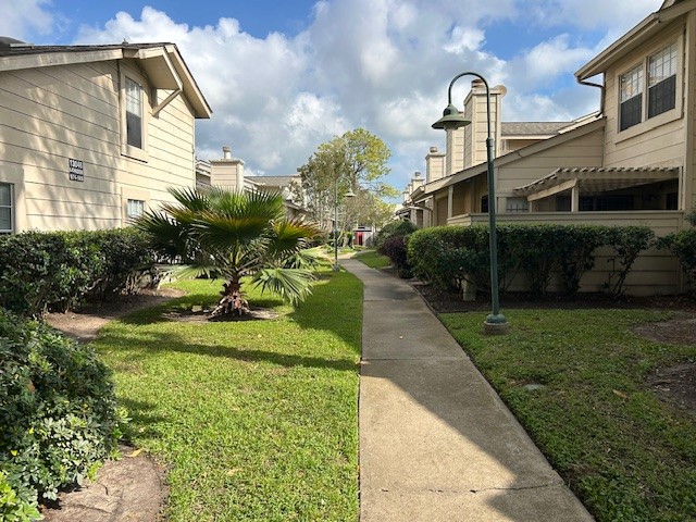 13046 Leader Street, Unit 976 Houston, TX 77072 - Photo 14 of 18 a front view of a house with garden