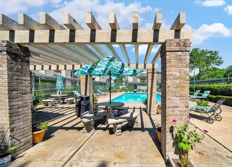 13046 Leader Street, Unit 976 Houston, TX 77072 - Photo 17 of 18 a building outdoor space with patio furniture and potted plants