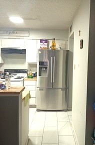 13046 Leader Street, Unit 976 Houston, TX 77072 - Photo 7 of 18 a kitchen with stainless steel appliances granite countertop a refrigerator and a stove