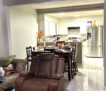 13046 Leader Street, Unit 976 Houston, TX 77072 - Photo 8 of 18 a living room with furniture a flat screen tv and a window