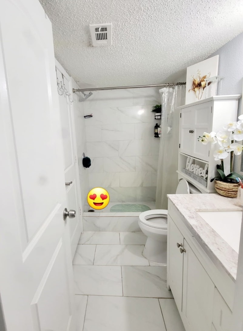 13046 Leader Street, Unit 976 Houston, TX 77072 - Photo 10 of 18 a bathroom with a sink a toilet and shower