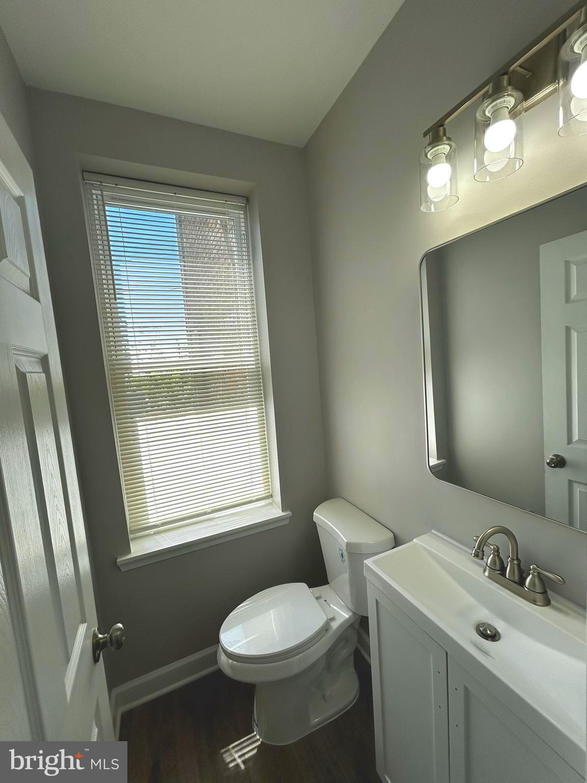 2815 East Chase Street Baltimore, MD 21213 - Photo 11 of 40 a bathroom with a sink toilet and mirror