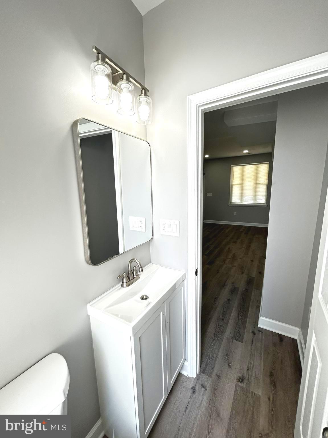 2815 East Chase Street Baltimore, MD 21213 - Photo 12 of 40 a bathroom with a sink and a mirror