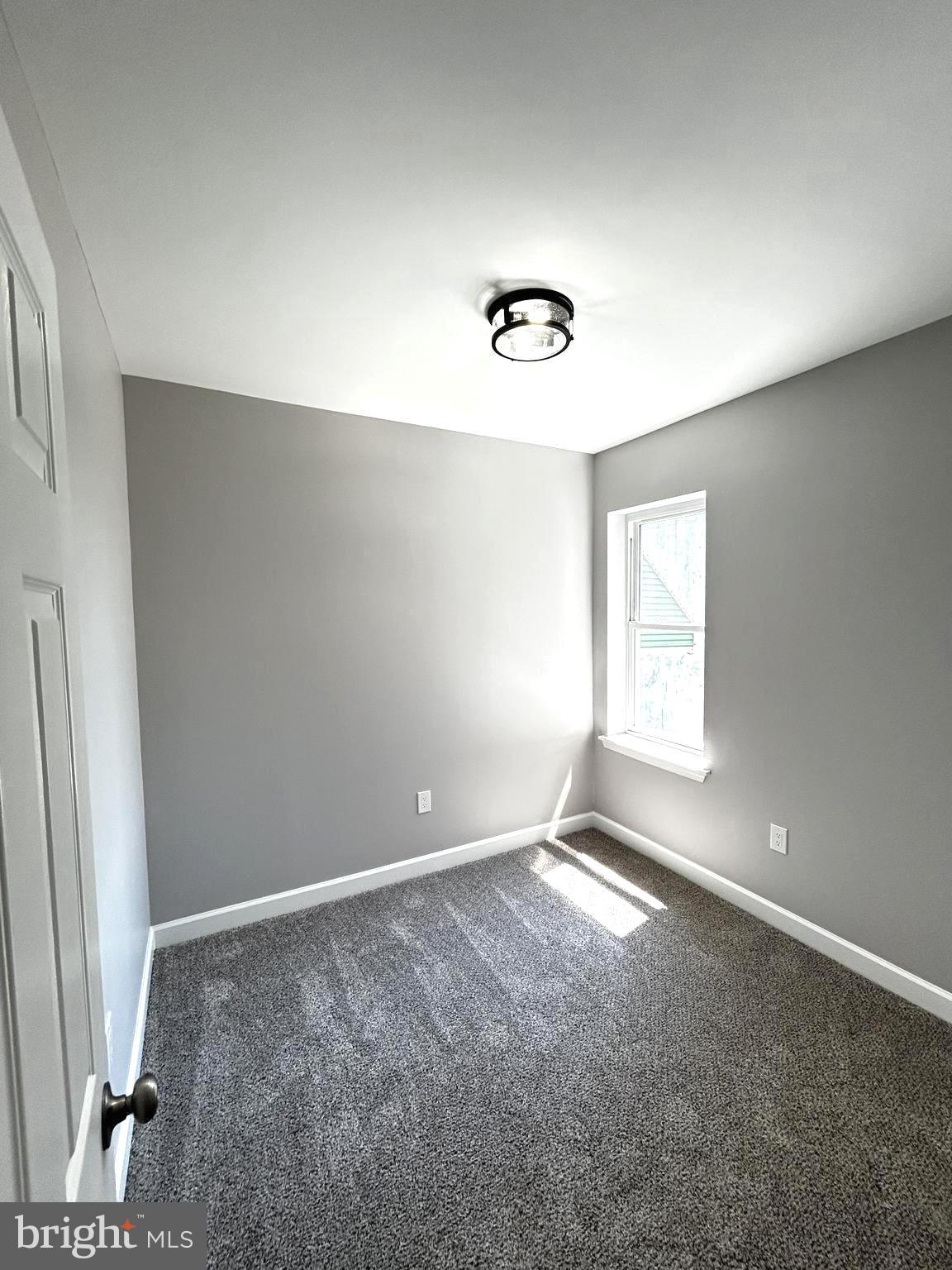 2815 East Chase Street Baltimore, MD 21213 - Photo 15 of 40 an empty room with windows