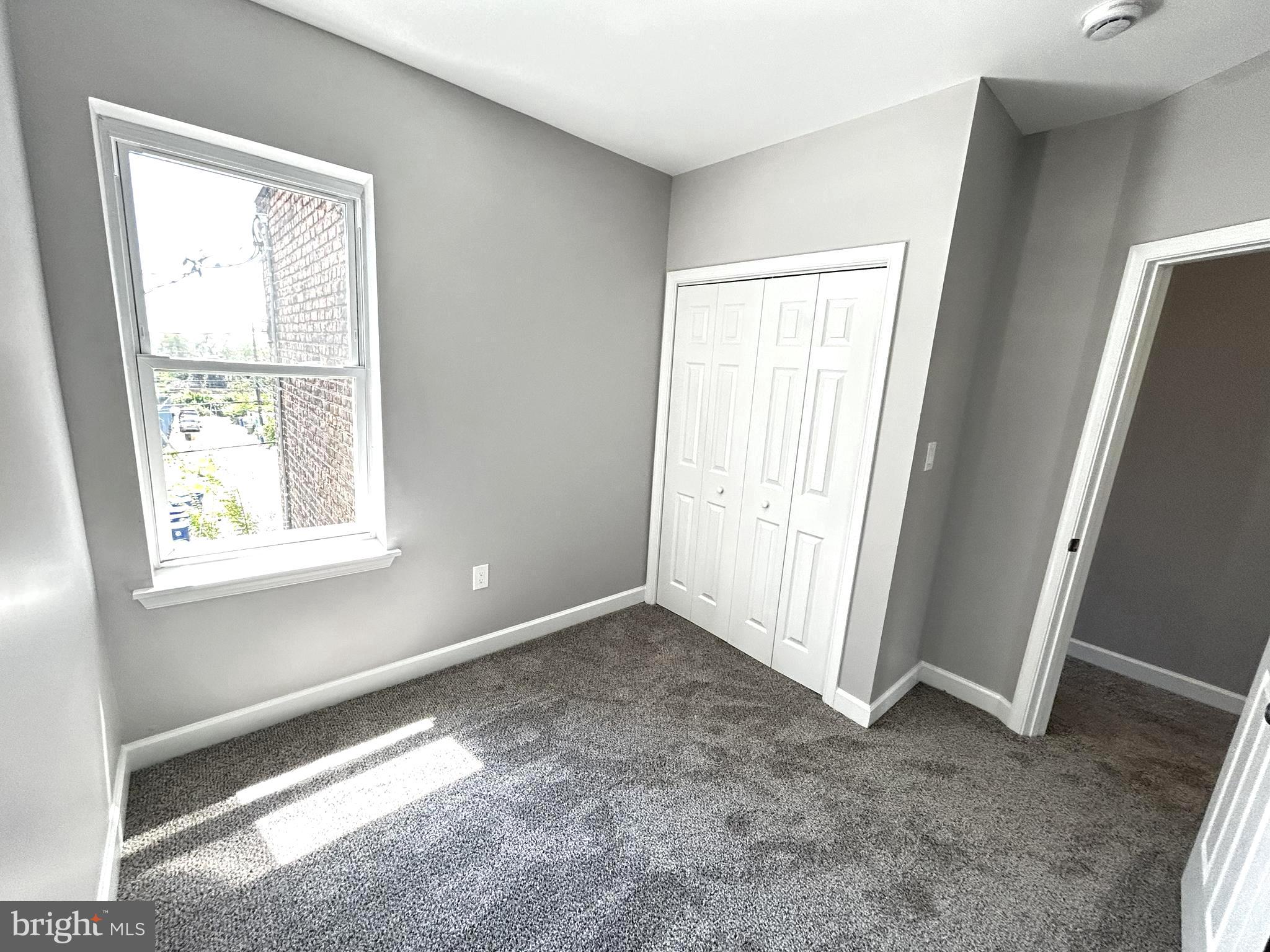 2815 East Chase Street Baltimore, MD 21213 - Photo 16 of 40 an empty room with windows