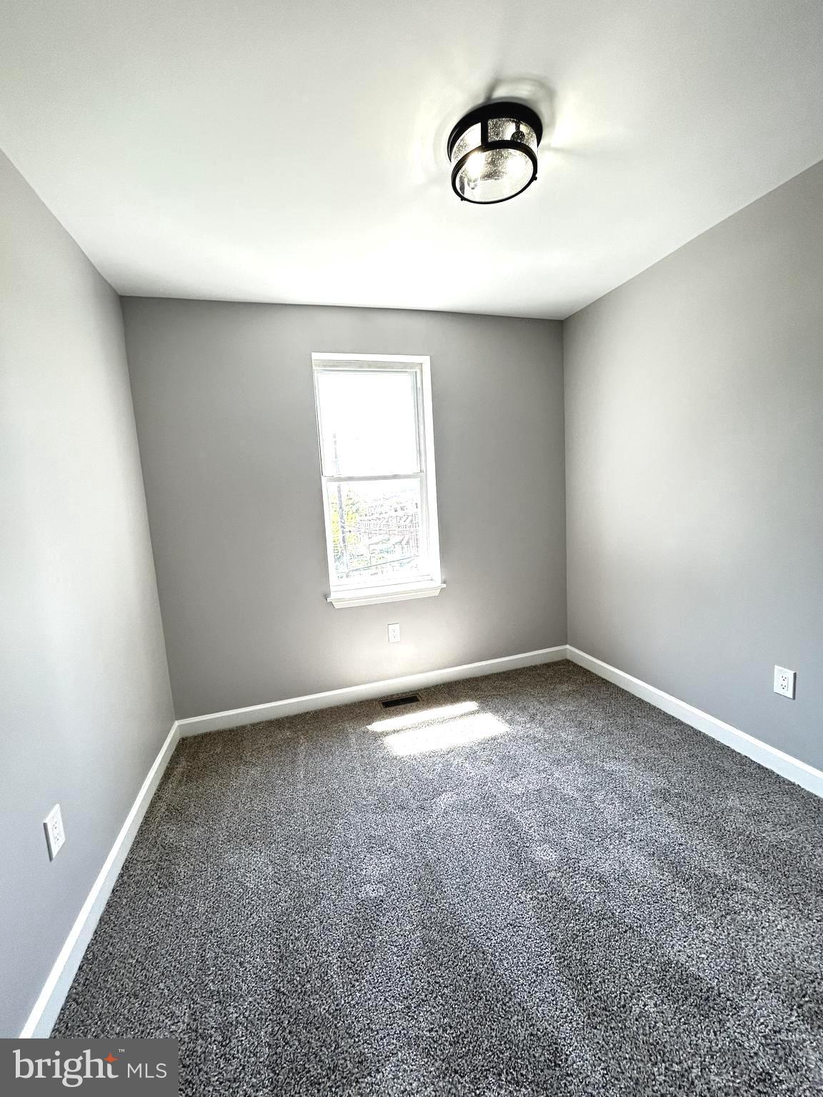 2815 East Chase Street Baltimore, MD 21213 - Photo 17 of 40 an empty room with a window