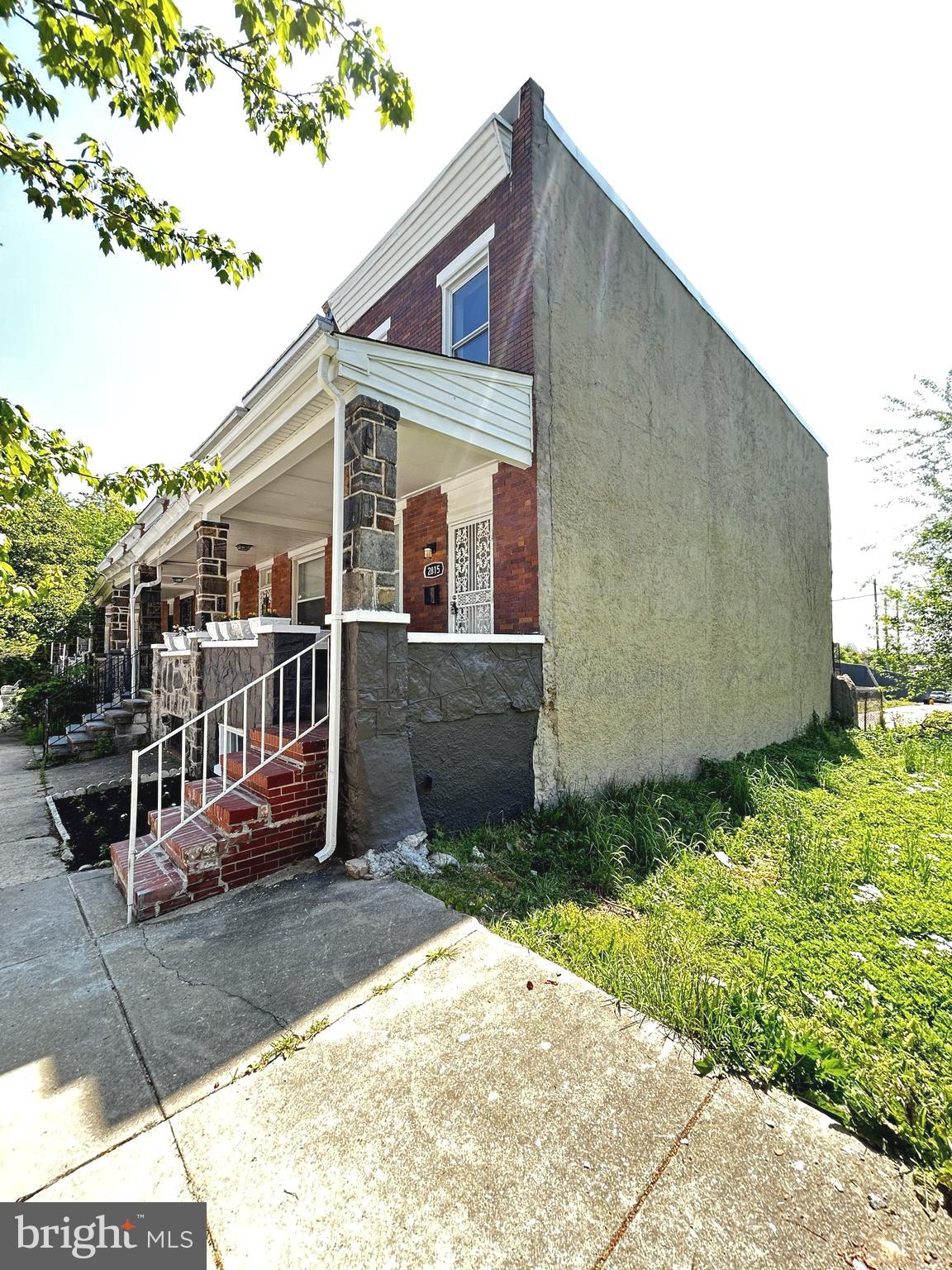 2815 East Chase Street Baltimore, MD 21213 - Photo 2 of 40 a front view of a house with a yard