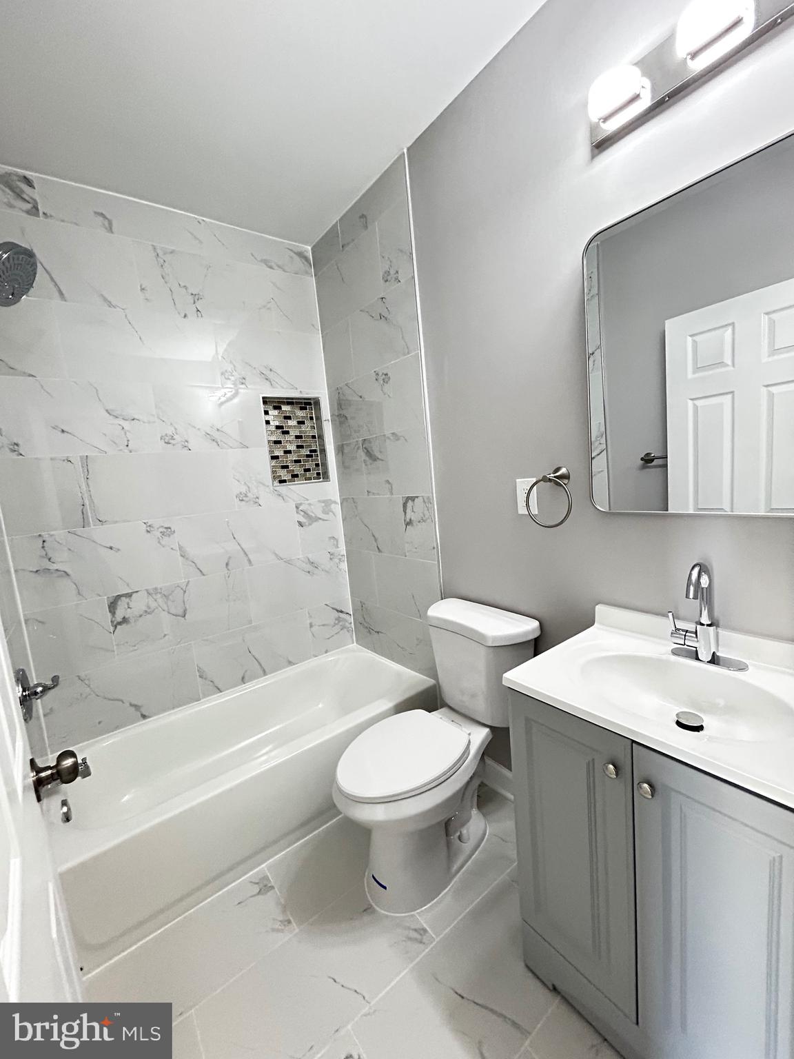 2815 East Chase Street Baltimore, MD 21213 - Photo 40 of 40 a bathroom with a sink a toilet and a bathtub