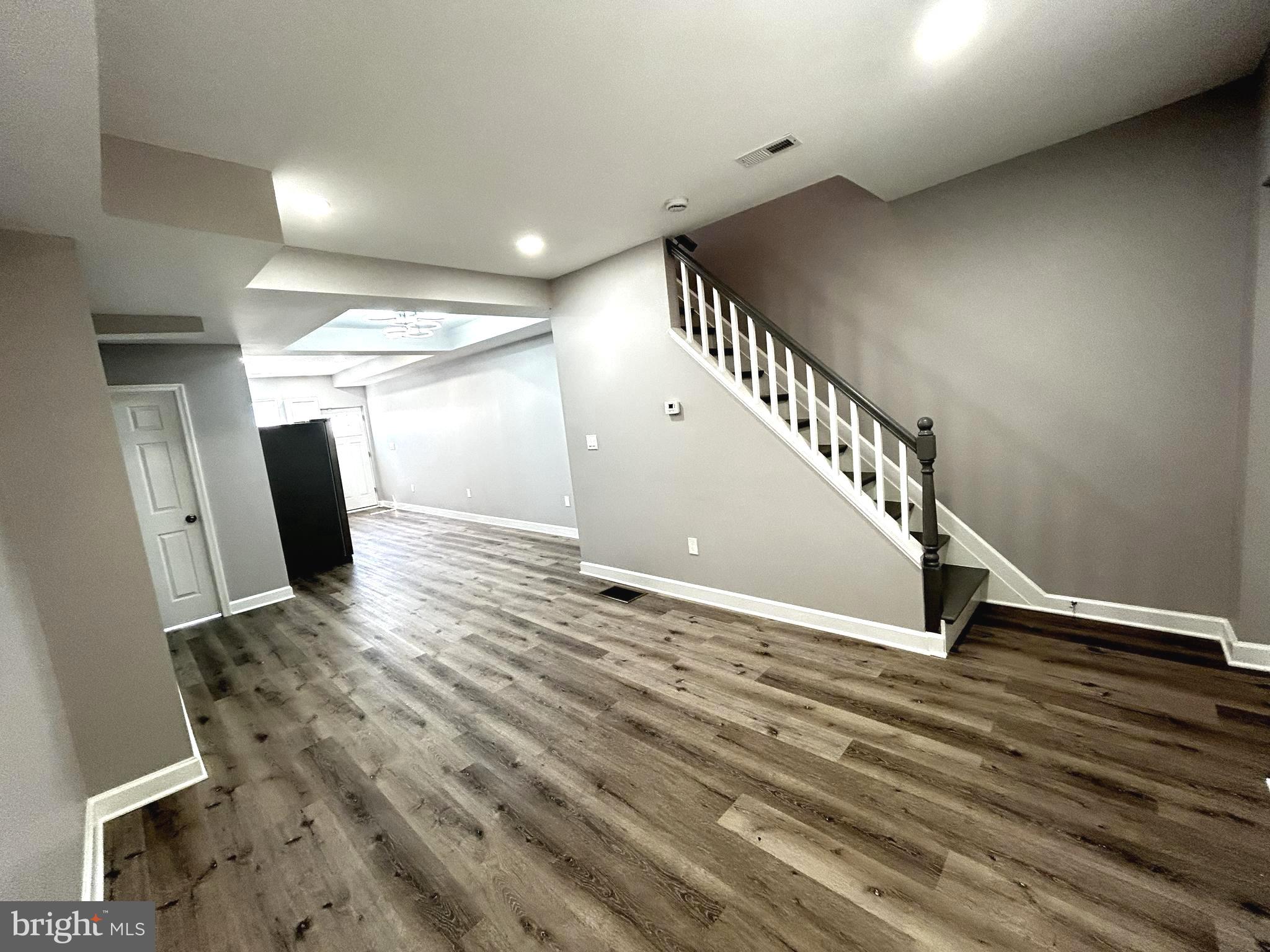 2815 East Chase Street Baltimore, MD 21213 - Photo 5 of 40 a view of an empty room with stairs