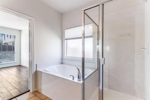 a bathroom with a bathtub and a shower