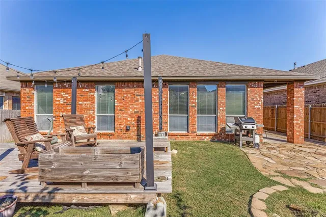a view of a house with backyard porch and sitting area