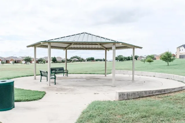 a view of a park with swings and slides