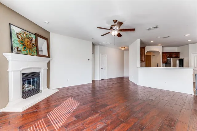 a view of a kitchen with an empty space and a fireplace