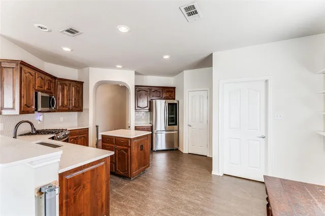 a view of a kitchen with electric appliances