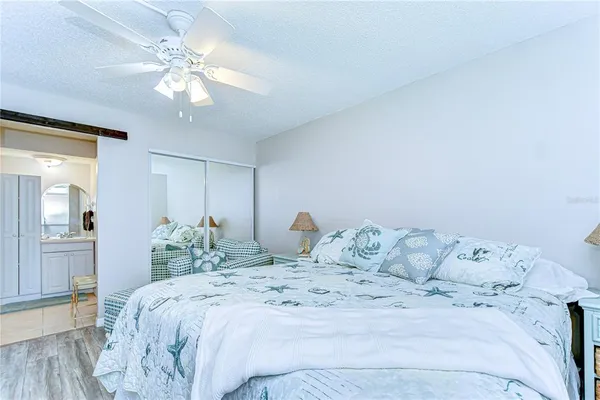 a bedroom with a large bed and a chandelier