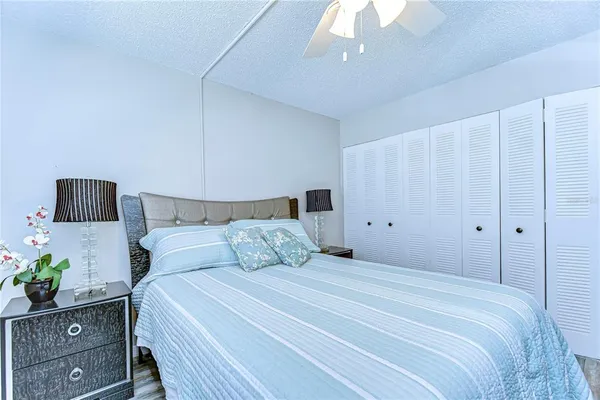 a bedroom with a bed and a potted plant