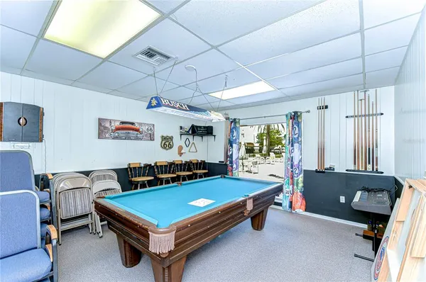 a living room with furniture and a pool table
