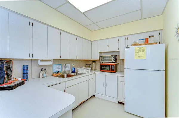 a kitchen with stainless steel appliances a refrigerator sink and cabinets