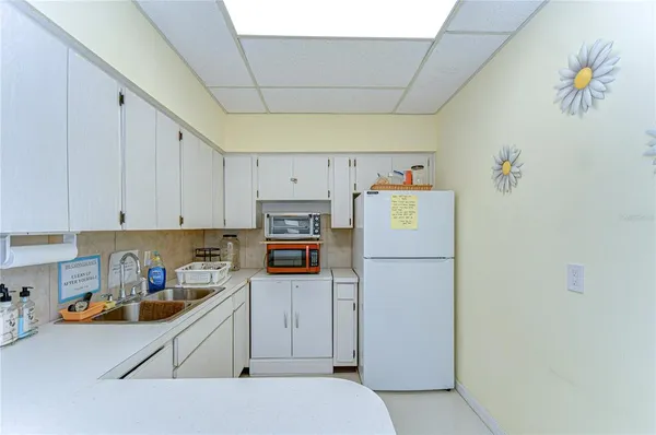 a kitchen with refrigerator and cabinets