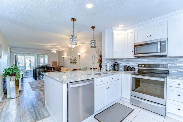 a kitchen with a stove top oven sink and cabinets