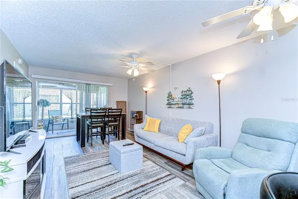 a living room with furniture and wooden floor