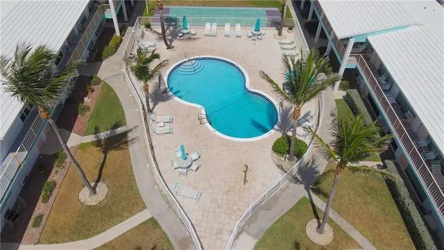 a large bed sitting in a bedroom next to a lamp