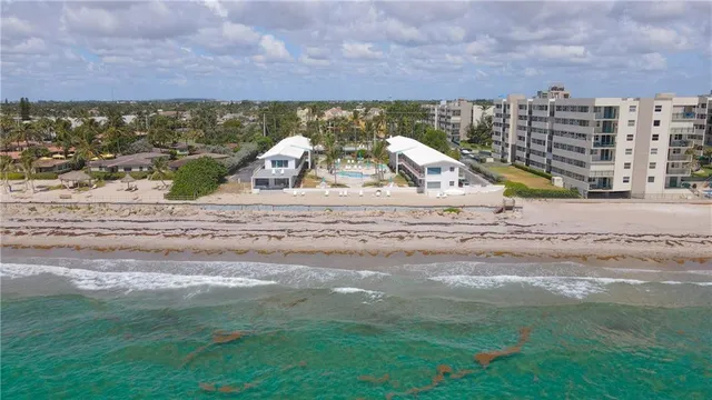 an aerial view of residential houses with outdoor space