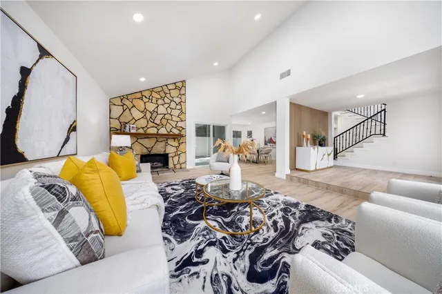 a living room with furniture and a fireplace