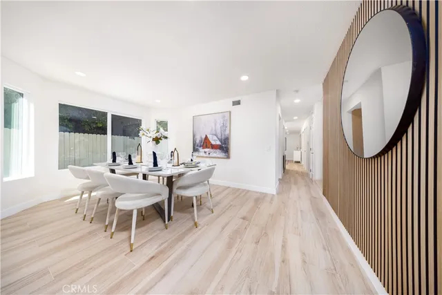 a dining room with furniture a mirror and wooden floor