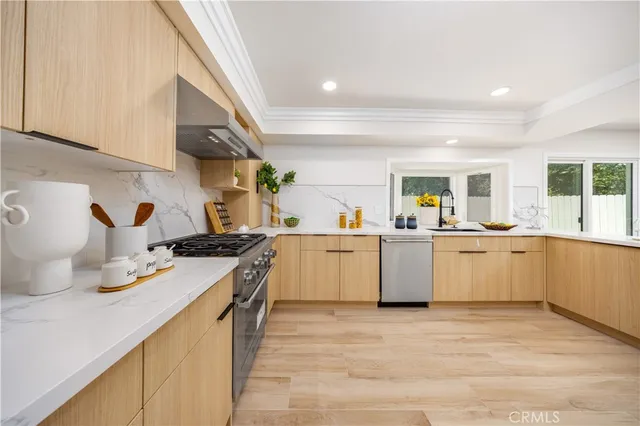 a kitchen with a sink stove and wooden cabinets