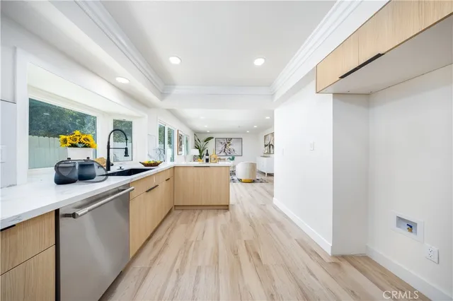 a large kitchen with stainless steel appliances a lot of counter space and wooden floor
