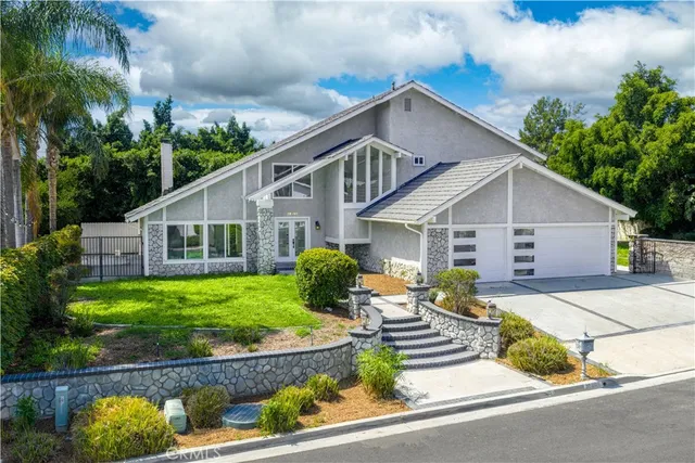 a front view of house with yard and green space