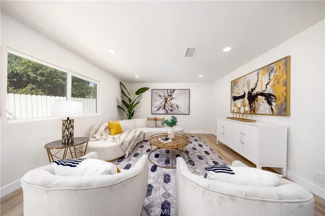 a living room with furniture and painting on the wall