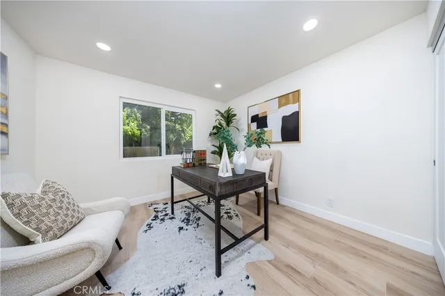 a living room with furniture a window and a flat screen tv