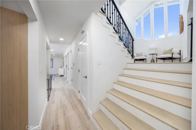 a view of entryway and hall with wooden floor
