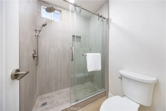 a bedroom with a bed and painting on the wall