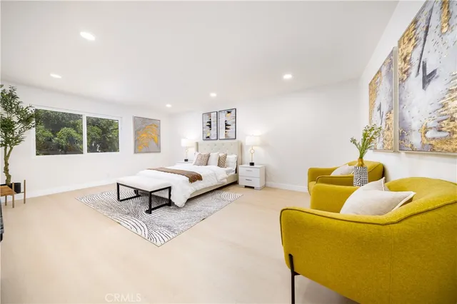 a bedroom with a bed and a potted plant