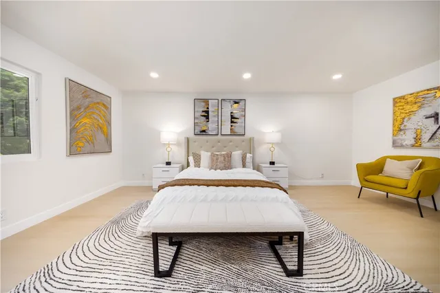 a bedroom with furniture and a large window